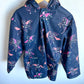 Navy blue jacket with pink unicorn pattern